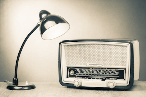 Retro old desk lamp and radio on table sepia photography