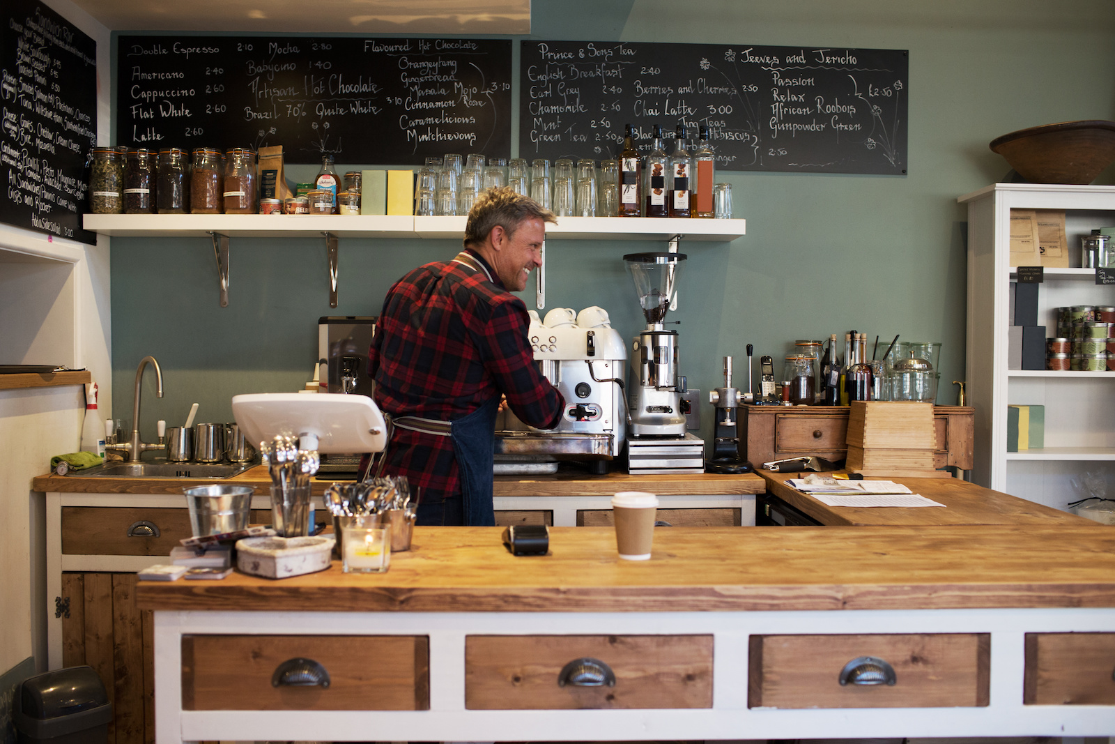 Male Barista Preparing Hot Drink In Coffee Shop