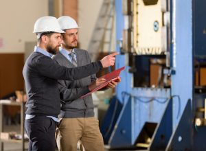 Two businessman working in factory